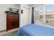 Bedroom with a window, wood dresser with TV and a serene blue color scheme at 2620 Lodi Cir # 103, Kissimmee, FL 34746