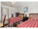 Bedroom featuring two twin beds with red linens, and dark wooden furniture at 2620 Lodi Cir # 103, Kissimmee, FL 34746