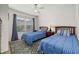 Bright bedroom with two twin beds, ceiling fan and a window with natural light at 2620 Lodi Cir # 103, Kissimmee, FL 34746