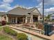 Clubhouse exterior featuring outdoor patio seating and landscaping with ramp access at 2620 Lodi Cir # 103, Kissimmee, FL 34746