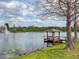 Scenic lake view featuring a gazebo on a pier and a fountain in the distance at 2620 Lodi Cir # 103, Kissimmee, FL 34746