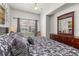 Bright bedroom featuring a queen bed, a large window, and dark wooden furniture at 2620 Lodi Cir # 103, Kissimmee, FL 34746