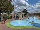 Community splash pad with colorful play structures, water features, and a shaded gazebo at 2620 Lodi Cir # 103, Kissimmee, FL 34746