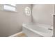 Bathroom soaking tub next to an architectural window at 265 Curtis Ave, Groveland, FL 34736