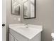 Bathroom features a white vanity with bright lights and mirror providing a functional space at 265 Curtis Ave, Groveland, FL 34736