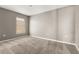 Neutral bedroom with carpeted floors and a window with blinds at 265 Curtis Ave, Groveland, FL 34736