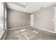Neutrally decorated bedroom features plush carpeting, and plenty of natural light at 265 Curtis Ave, Groveland, FL 34736