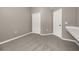 Neutral bedroom featuring soft carpeting, closet, and built in desk great for a guest room or home office at 265 Curtis Ave, Groveland, FL 34736