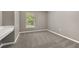 Cozy bedroom featuring plush carpet, natural light from the window, and a built-in desk for added convenience at 265 Curtis Ave, Groveland, FL 34736
