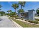 Elegant community sign for Lake Dot Landing, surrounded by lush landscaping and palm trees at 265 Curtis Ave, Groveland, FL 34736