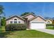Beautiful single-story home with a manicured lawn and a convenient two-car garage, perfect for suburban living at 265 Curtis Ave, Groveland, FL 34736