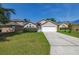 Charming single-story home with a well-manicured lawn and a two-car garage, offering great curb appeal at 265 Curtis Ave, Groveland, FL 34736