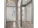 Inviting foyer with archway, showcasing wood-look flooring and neutral wall paint throughout at 265 Curtis Ave, Groveland, FL 34736