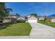 Charming single-story home with a well-maintained lawn and a two-car garage on a sunny day at 265 Curtis Ave, Groveland, FL 34736