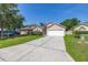 Attractive one-story home with a green lawn and two car garage, in a quiet neighborhood at 265 Curtis Ave, Groveland, FL 34736