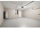 Spacious garage with epoxy flooring, water heater, and room for parking cars and extra storage solutions at 265 Curtis Ave, Groveland, FL 34736