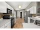 Spacious kitchen with stainless steel appliances and tile floors at 265 Curtis Ave, Groveland, FL 34736