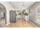 Open concept kitchen with stainless steel appliances, tile floors and tiled backsplash at 265 Curtis Ave, Groveland, FL 34736