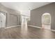 Bright living room featuring wood-look floors and arched doorways at 265 Curtis Ave, Groveland, FL 34736