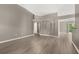 Spacious living room with wood-look floors and arched doorways at 265 Curtis Ave, Groveland, FL 34736