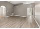 Open living room featuring arched doorways and wood-look floors at 265 Curtis Ave, Groveland, FL 34736