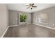 Bright living room featuring vinyl plank flooring, a ceiling fan, and a sliding door at 265 Curtis Ave, Groveland, FL 34736