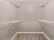 Spacious walk-in closet featuring carpeted floor and white wire shelving perfect for organized storage solutions at 265 Curtis Ave, Groveland, FL 34736