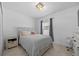 Bright bedroom with a queen bed, neutral decor, and a light wood nightstand at 2715 Barclay Ln, Kissimmee, FL 34743