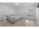 Minimalist bedroom featuring a queen bed, neutral tones, and a window offering outdoor views at 2715 Barclay Ln, Kissimmee, FL 34743