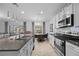 Well-equipped kitchen with granite countertops, stainless steel appliances, and a breakfast bar overlooking the living area at 2715 Barclay Ln, Kissimmee, FL 34743