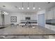 Spacious kitchen with granite countertops, stainless steel appliances, a breakfast bar, and modern lighting at 2715 Barclay Ln, Kissimmee, FL 34743