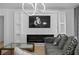 Stylish living room featuring a modern fireplace, decorative wall panel, and comfortable seating area at 2715 Barclay Ln, Kissimmee, FL 34743