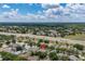 Overhead perspective reveals houses in a verdant community with a highway nearby at 3125 Samosa Hill Cir, Clermont, FL 34714