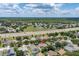 Expansive aerial view of a community with lush greenery and a nearby highway at 3125 Samosa Hill Cir, Clermont, FL 34714