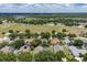 Aerial view featuring rooftops, scattered trees and landscaping, capturing the essence of community living at 3125 Samosa Hill Cir, Clermont, FL 34714