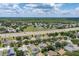 Wide aerial shot showcases the neighborhood with homes, trees, and distant skyline at 3125 Samosa Hill Cir, Clermont, FL 34714