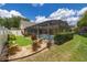Lush backyard featuring a pool, putting green, landscaping, and privacy fence. Great for relaxation and outdoor living at 3125 Samosa Hill Cir, Clermont, FL 34714