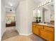 Bathroom featuring a vanity with wood cabinets that leads into the main bedroom at 3125 Samosa Hill Cir, Clermont, FL 34714