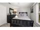 Cozy bedroom featuring a black wood bed frame, dresser, and plush bedding at 3125 Samosa Hill Cir, Clermont, FL 34714