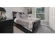 Bedroom with a large window offering natural light and a view of the trees at 3125 Samosa Hill Cir, Clermont, FL 34714