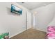 Bright bedroom with a TV, cozy carpet, and doorway leading to other rooms at 3125 Samosa Hill Cir, Clermont, FL 34714