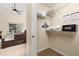 Walk-in closet next to a main bedroom provides ample storage with shelving and hanging space for an organized wardrobe at 3125 Samosa Hill Cir, Clermont, FL 34714