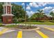 Street-level view of a community entrance with brick tower, American flag, and 'Orange Tree' signage at 3125 Samosa Hill Cir, Clermont, FL 34714