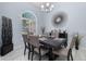 Elegant dining room featuring a large window, stylish light fixture, and modern decor at 3125 Samosa Hill Cir, Clermont, FL 34714