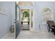 Bright and open entryway with tiled floors and an arched doorway leading to the front porch at 3125 Samosa Hill Cir, Clermont, FL 34714