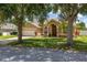 Beautiful home featuring mature trees shading the front and a well-maintained yard at 3125 Samosa Hill Cir, Clermont, FL 34714