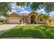 Charming single-story home featuring a well-manicured lawn and inviting curb appeal at 3125 Samosa Hill Cir, Clermont, FL 34714