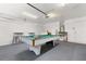 Clean garage space featuring billiard table, overhead lighting and garage door opener at 3125 Samosa Hill Cir, Clermont, FL 34714