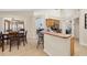 Kitchen featuring a breakfast bar, stainless steel appliances, and views into the dining area at 3125 Samosa Hill Cir, Clermont, FL 34714