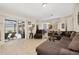 Open concept living room with access to outdoor living space and views of the kitchen at 3125 Samosa Hill Cir, Clermont, FL 34714